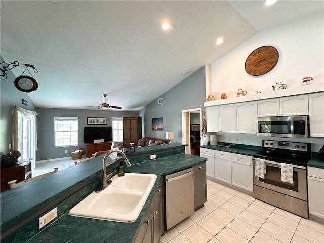 3580 Savannahs Trl, Merritt Island, FL 32953 - kitchen with a sink, open floor plan, dark countertops, and stainless steel appliances