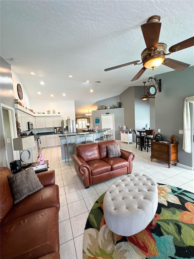 3580 Savannahs Trl, Merritt Island, FL 32953 - living area featuring light tile patterned floors, a textured ceiling, vaulted ceiling, and a ceiling fan