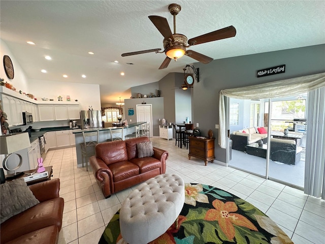 3580 Savannahs Trl, Merritt Island, FL 32953 - living area with light tile patterned floors, ceiling fan with notable chandelier, vaulted ceiling, and a textured ceiling