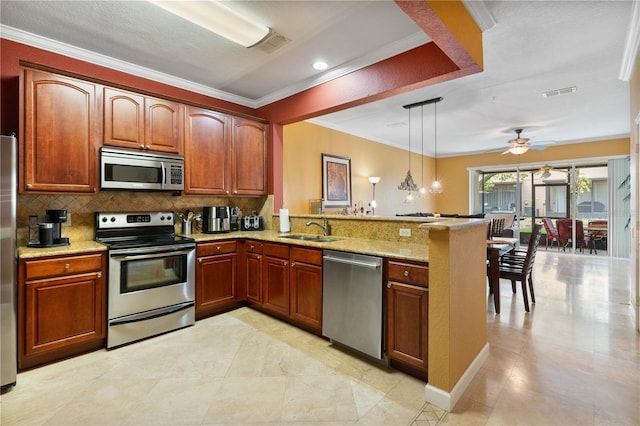 kitchen featuring light stone countertops, visible vents, a peninsula, a sink, and stainless steel appliances