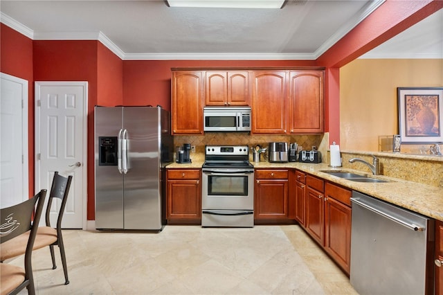 kitchen with ornamental molding, a sink, appliances with stainless steel finishes, decorative backsplash, and light stone countertops