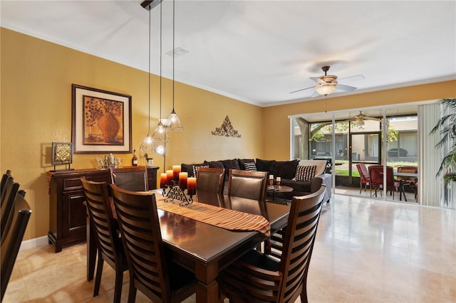 dining room with visible vents, baseboards, crown molding, and ceiling fan