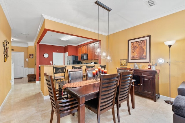 dining room featuring visible vents and crown molding