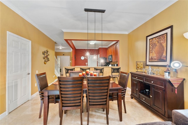 dining room featuring baseboards and ornamental molding