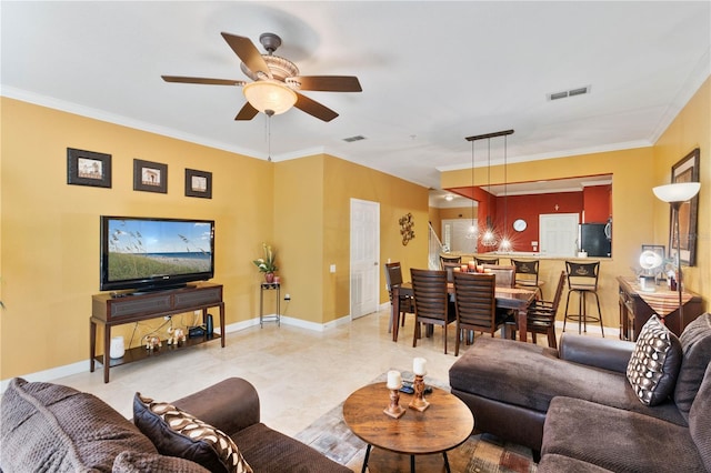 living room with visible vents, ceiling fan, baseboards, and ornamental molding