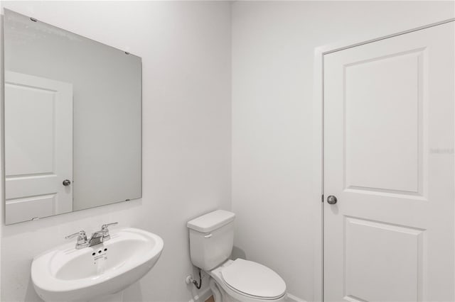 bathroom with toilet and a sink