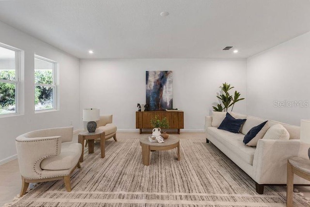 living room featuring recessed lighting, visible vents, and baseboards