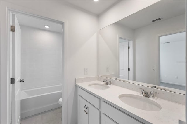 full bath with double vanity, toilet, visible vents, and a sink