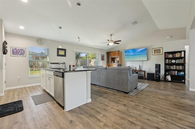 kitchen with visible vents, open floor plan, light wood-style flooring, white cabinetry, and stainless steel dishwasher