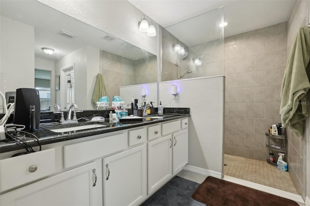 full bathroom with a walk in shower, visible vents, and a sink