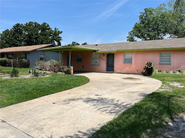 4845 Elese St, Orlando, FL 32811 - ranch-style home featuring driveway, concrete block siding, a front yard, and a carport
