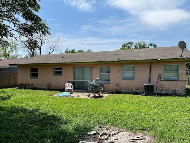 4845 Elese St, Orlando, FL 32811 - back of property with concrete block siding, central AC unit, a patio area, and roof with shingles
