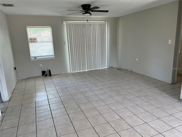 4845 Elese St, Orlando, FL 32811 - empty room with a ceiling fan and light tile patterned floors