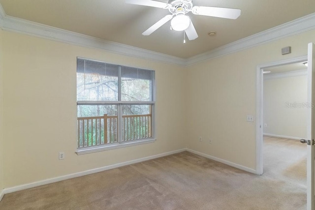 empty room with crown molding, light colored carpet, baseboards, and ceiling fan