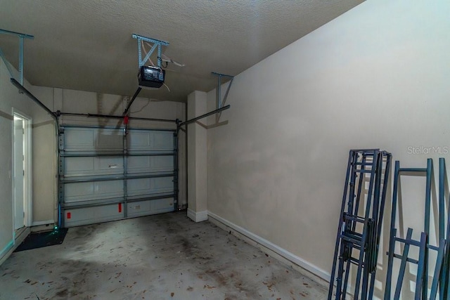 garage with a garage door opener and baseboards