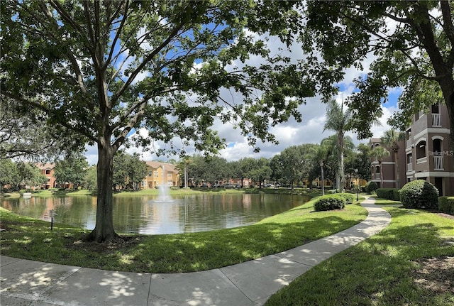 view of home's community featuring a water view and a lawn