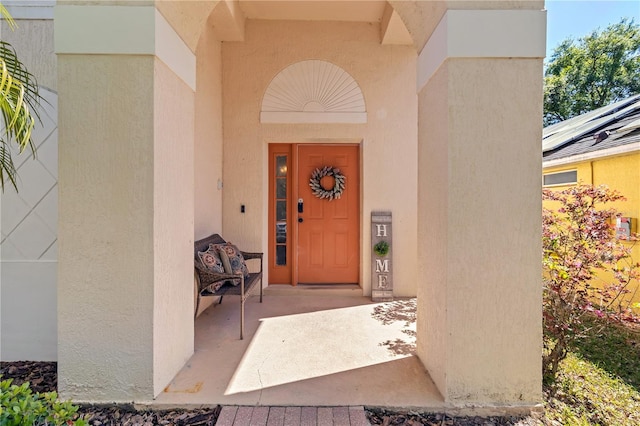 view of exterior entry with stucco siding