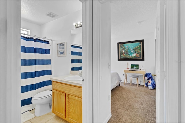 bathroom featuring tile patterned floors, visible vents, toilet, a textured ceiling, and vanity