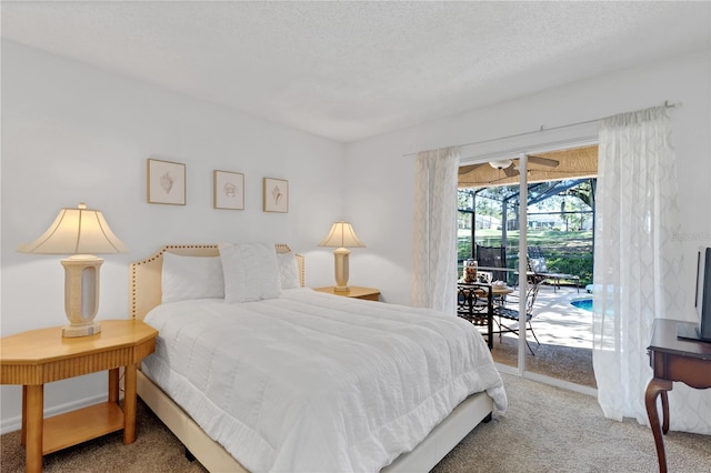 bedroom featuring access to exterior, carpet flooring, baseboards, and a textured ceiling