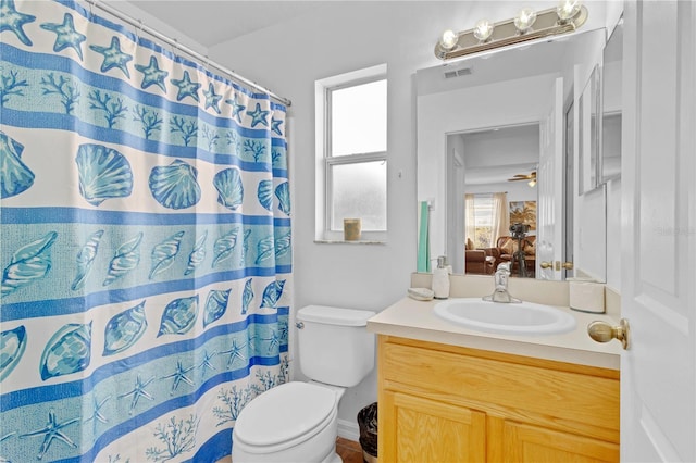 ensuite bathroom featuring connected bathroom, vanity, a shower with shower curtain, and toilet