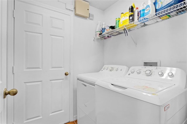 clothes washing area featuring laundry area and washing machine and clothes dryer