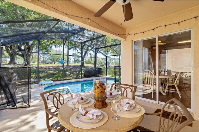 view of patio / terrace featuring an outdoor pool, a lanai, and ceiling fan