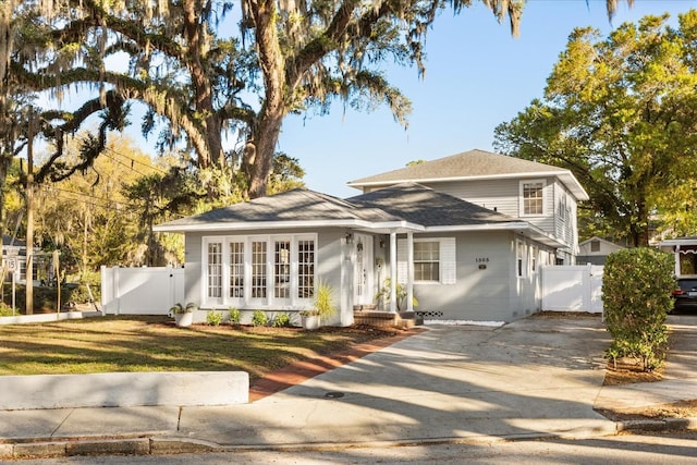 view of front of house with driveway, fence, and a gate