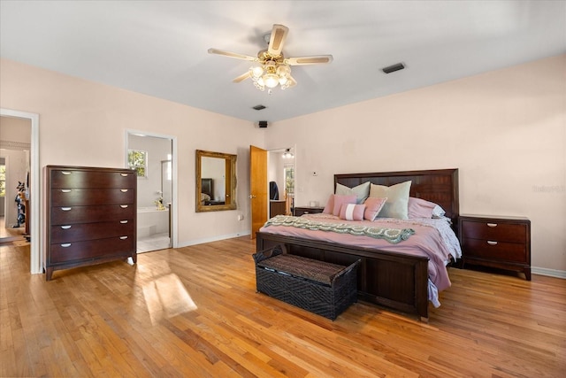 bedroom with visible vents, multiple windows, baseboards, and wood finished floors