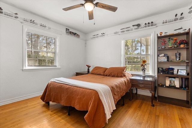 bedroom featuring ceiling fan, baseboards, and light wood-style flooring