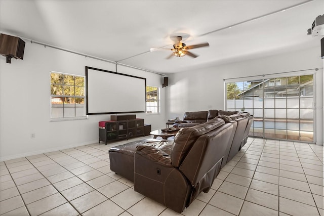 cinema with light tile patterned floors, baseboards, and ceiling fan