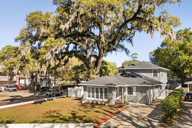 traditional home with french doors and a front lawn