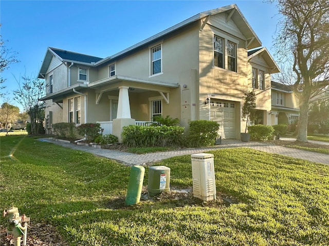 view of front facade featuring stucco siding, decorative driveway, a porch, a front yard, and a garage