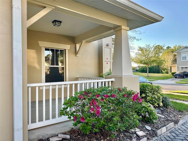 property entrance featuring stucco siding and a porch