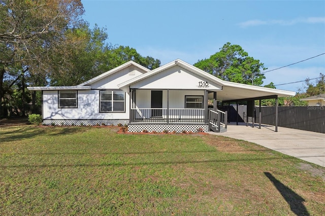 view of front facade with fence, a porch, a front yard, a carport, and driveway