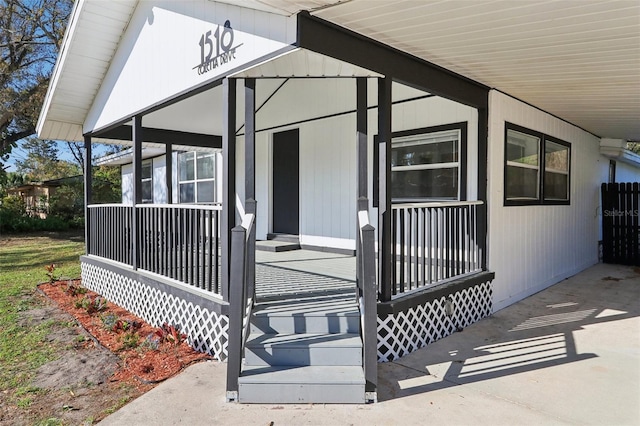 doorway to property featuring covered porch