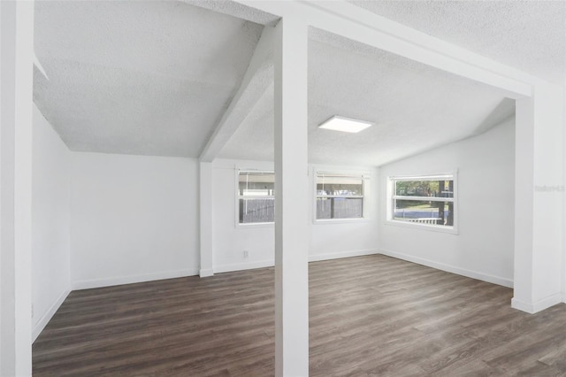 bonus room featuring a textured ceiling, wood finished floors, and vaulted ceiling