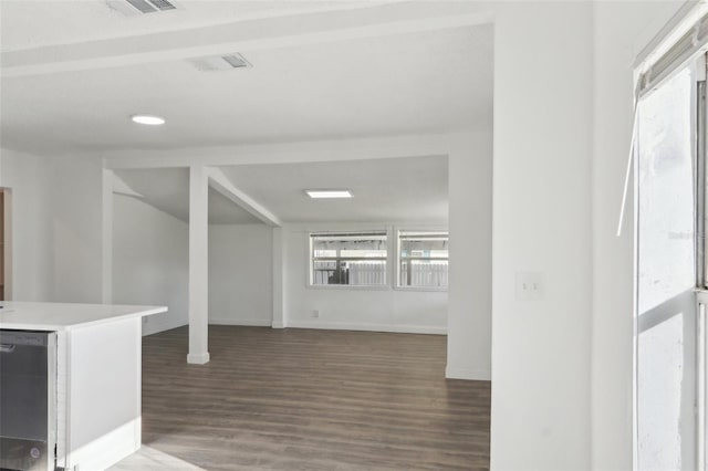 interior space featuring wood finished floors, visible vents, and baseboards