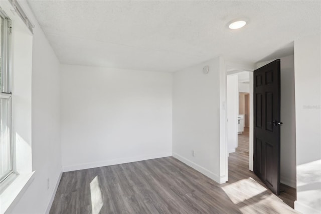 empty room with wood finished floors and baseboards