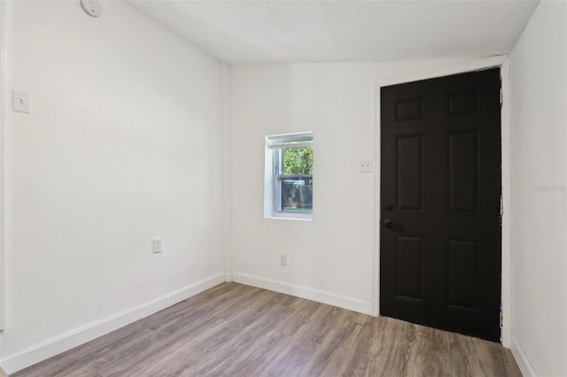 unfurnished room featuring light wood-type flooring and baseboards