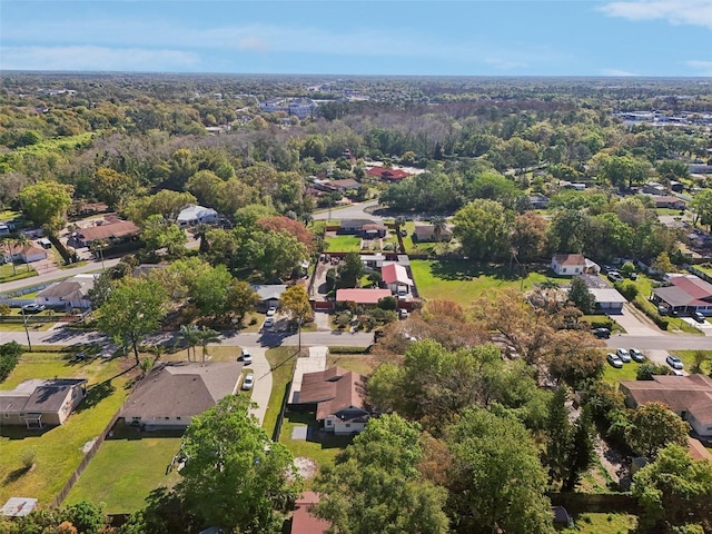 birds eye view of property with a wooded view and a residential view