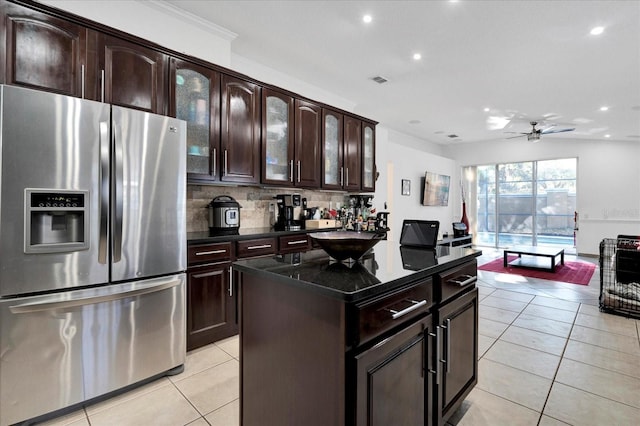 kitchen featuring decorative backsplash, light tile patterned flooring, stainless steel fridge with ice dispenser, and a ceiling fan