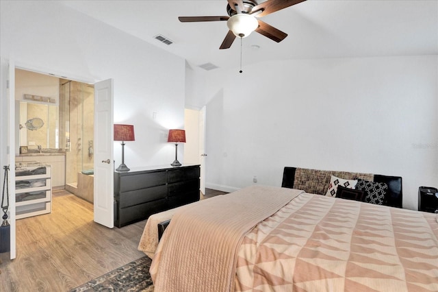 bedroom with wood finished floors, visible vents, ensuite bathroom, and ceiling fan