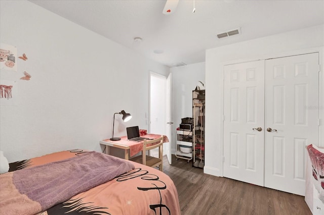 bedroom with visible vents, baseboards, a closet, and wood finished floors