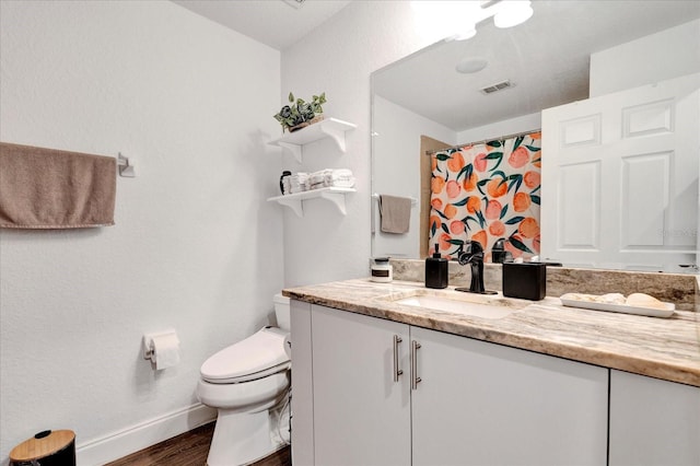 full bath featuring visible vents, baseboards, toilet, wood finished floors, and vanity