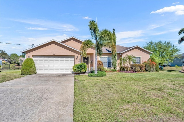 ranch-style home with a front yard, concrete driveway, an attached garage, and stucco siding