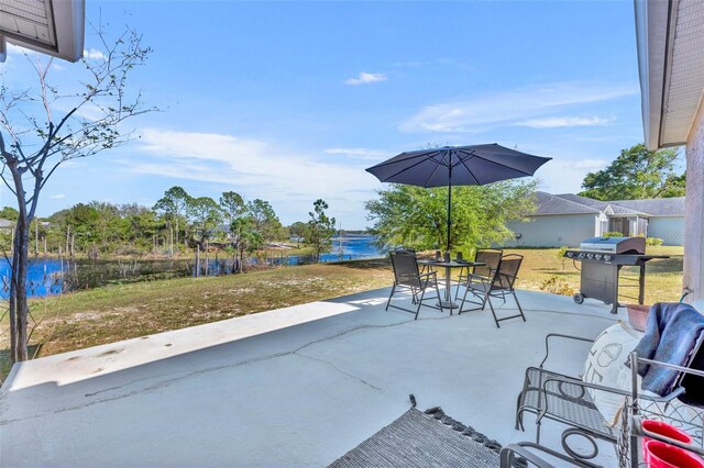 view of patio featuring outdoor dining space and a water view