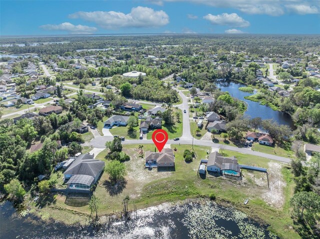 drone / aerial view with a residential view and a water view