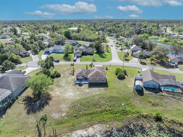 bird's eye view featuring a residential view and a wooded view