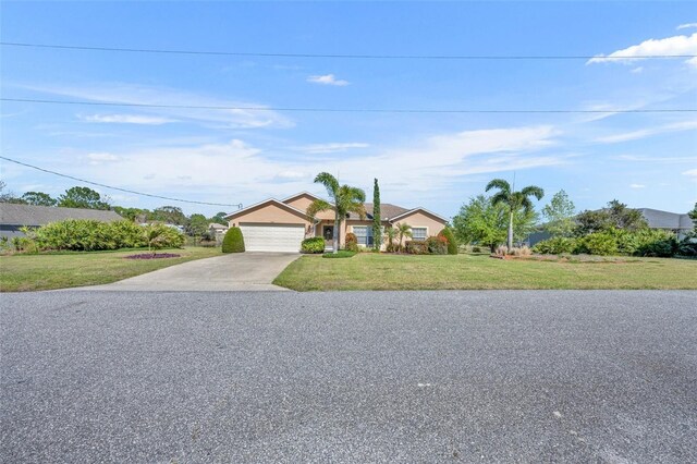 view of front of home featuring an attached garage, concrete driveway, and a front lawn