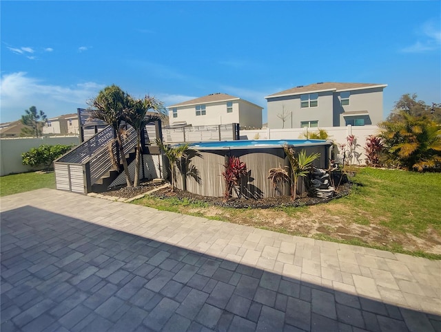 exterior space featuring a fenced in pool, a fenced backyard, and stairway